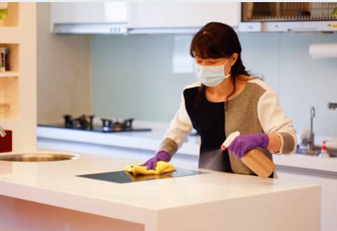  Homeowner cleaning cabinet interior as part of how to remove smoke smell after fire