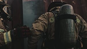 Firefighter in a fire and rescue operation before Fire and Smoke Damage Restoration in Fort Lauderdale: What to Do in the First 2 Hours