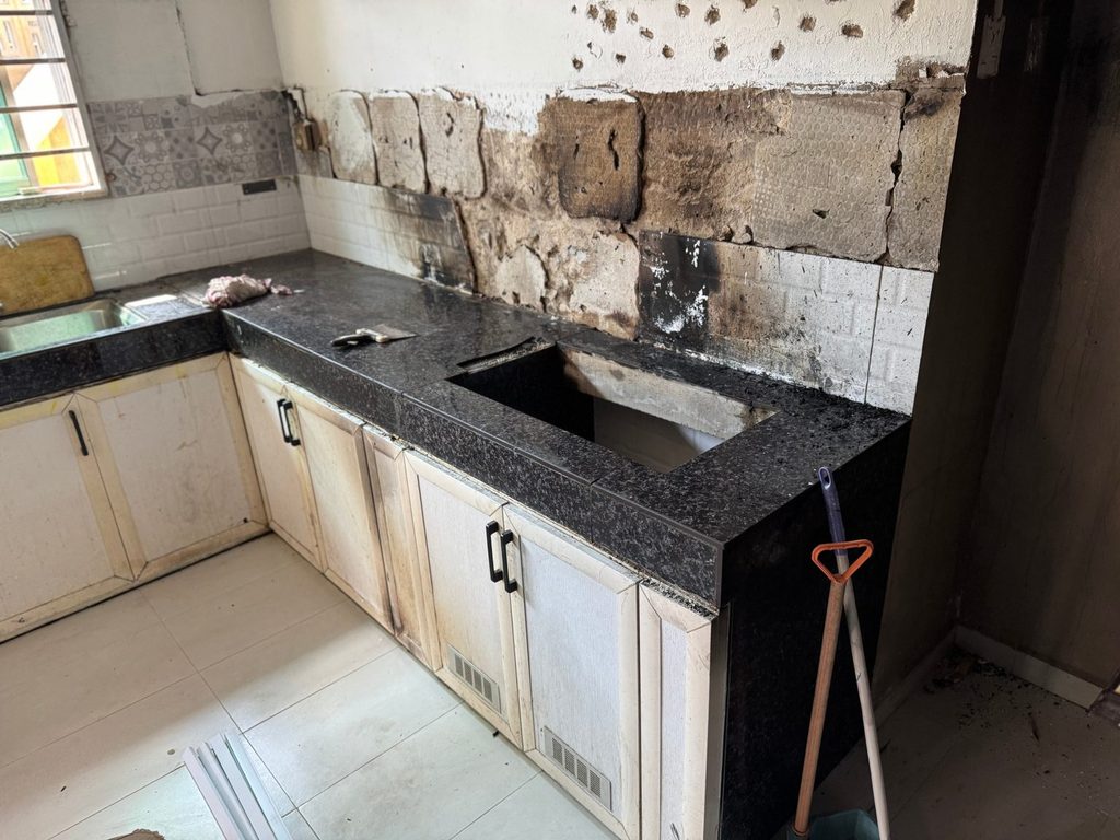 Fire-damaged kitchen with soot-stained cabinets: what to throw away after a house fire