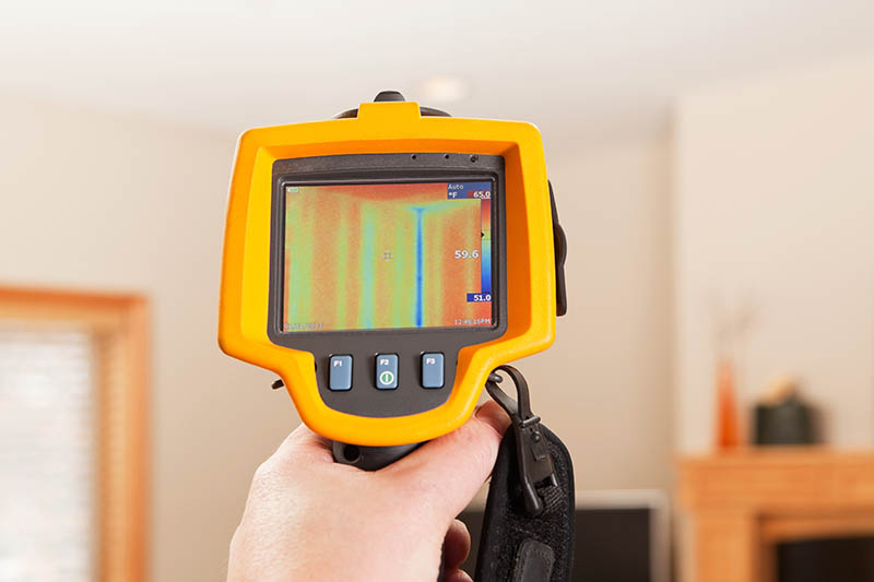 A digital moisture map showing hidden pockets of water saturation behind a living room wall