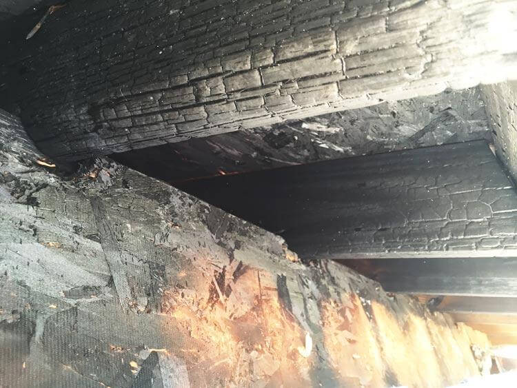 Smoke-damaged ceiling and walls being inspected by restoration specialists