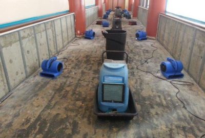 water damage clean up crew working inside home Ontario California