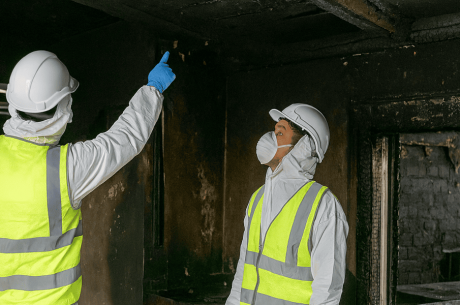 Professional fire restoration team assessing a commercial warehouse interior after a structural fire in Rancho Cucamonga