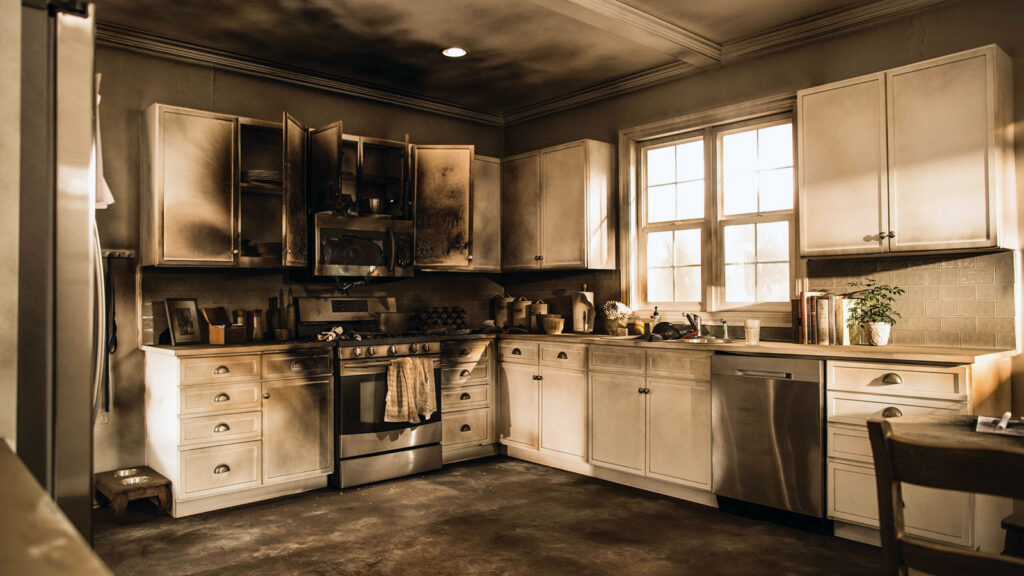 Fire restoration team assessing damage inside a residential home after a kitchen fire