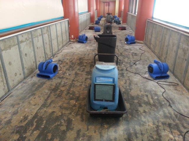 water damage clean up crew working inside home Ontario California