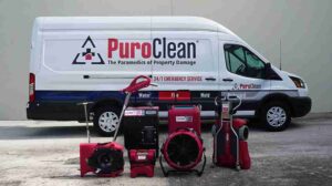 A certified restoration technician using a truck-mounted extraction vacuum to clear floodwater from a Rancho Cucamonga commercial property