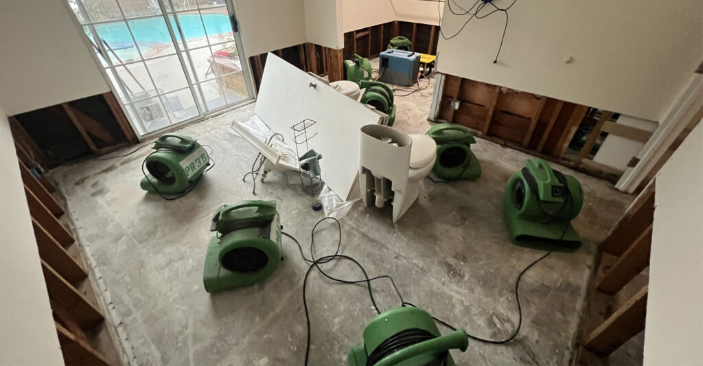 IICRC certified water mitigation technician using professional moisture detection equipment during a water damage assessment in a Rancho Cucamonga CA home
