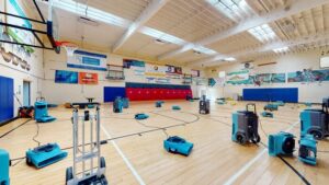 Water damage clean up crew responding to flooding in an indoor sports training facility locker room in Rancho Cucamonga CA requiring professional extraction and restoration