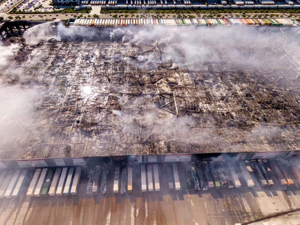 Emergency water restoration response inside a flooded warehouse distribution center in Rancho Cucamonga CA following a fire suppression system activation requiring large scale commercial restoration
