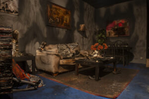 fire‑damaged living room interior with debris and burned furniture