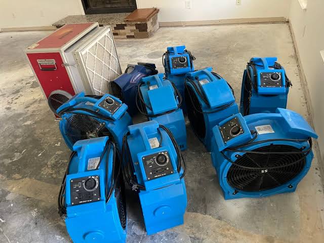 Water damage restoration service technician assessing water damaged medical equipment and treatment chairs in a Rancho Cucamonga CA dental office requiring specialized decontamination
