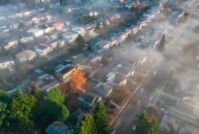 Renton, Washington, homes during summer haze, showing dry terrain and wildfire risk.