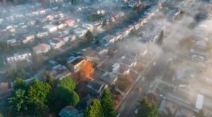 Renton, Washington, homes during summer haze, showing dry terrain and wildfire risk.