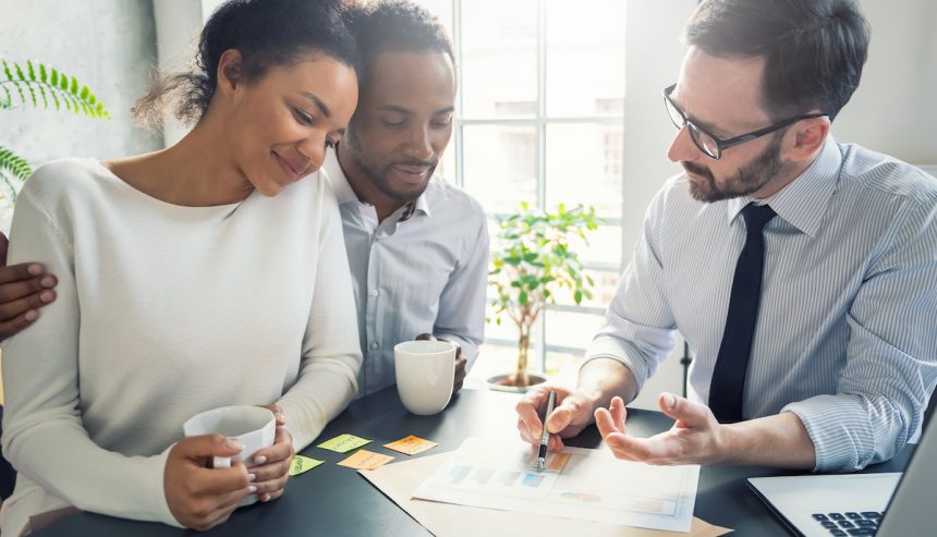 a group of men looking at a paper