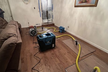 Technician arriving at a Ridgewood home with water extraction equipment