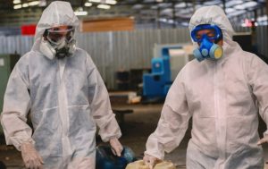 Certified PuroClean technicians in full personal protective equipment (PPE) performing biohazard cleanup in a Ridgewood, NJ home