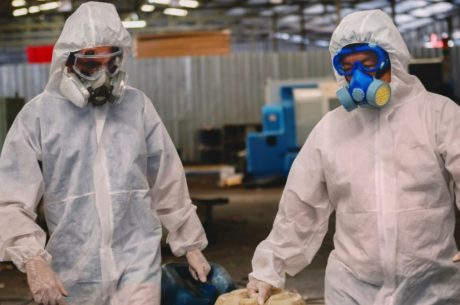 Certified PuroClean technicians in full personal protective equipment (PPE) performing biohazard cleanup in a Ridgewood, NJ home