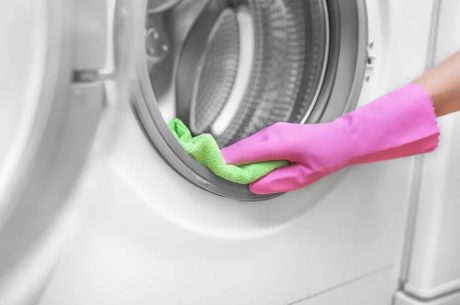 cleaning washing machine with glove and cloth