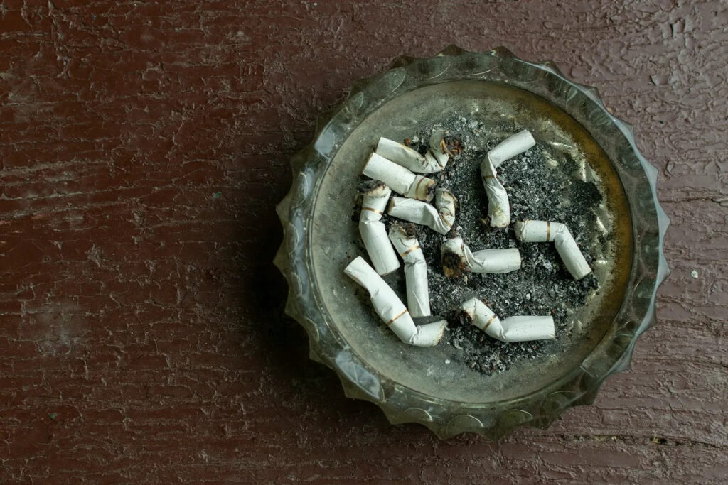 Dirty ashtray with crumpled cigarettes