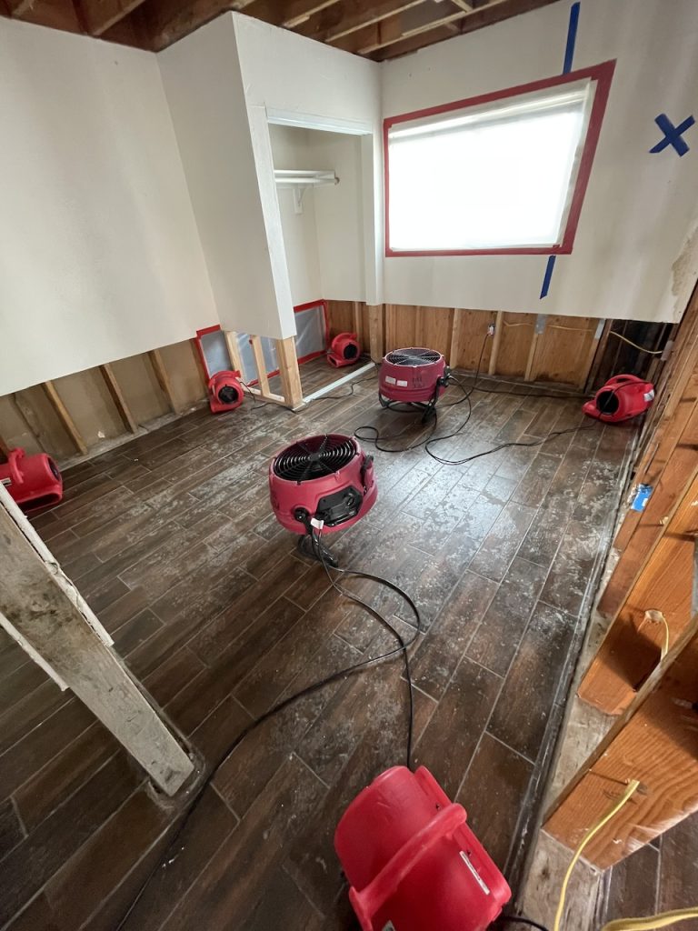 Industrial air movers dry the home's structure.