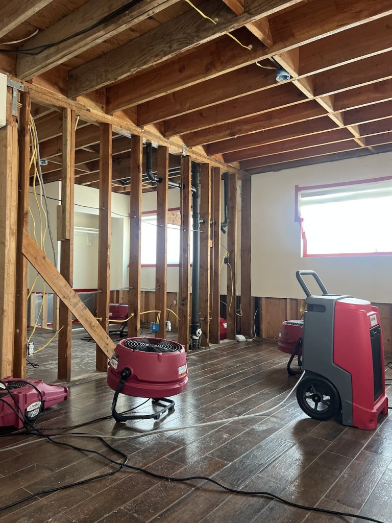 Industrial air movers dry the home's structure.