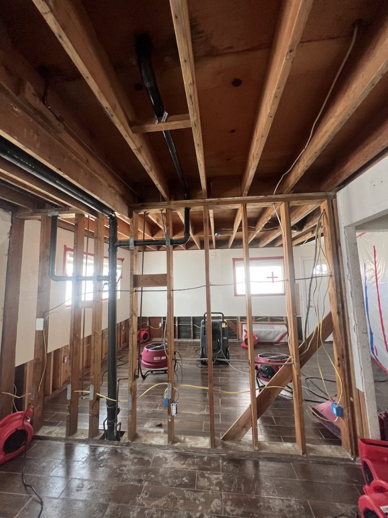 Industrial air movers dry the home's structure.