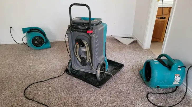 Air movers and dehumidifiers strategically placed throughout a Florida home to stop moisture spread