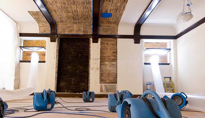 Water extraction equipment staged in a hallway of a Sarasota condominium building