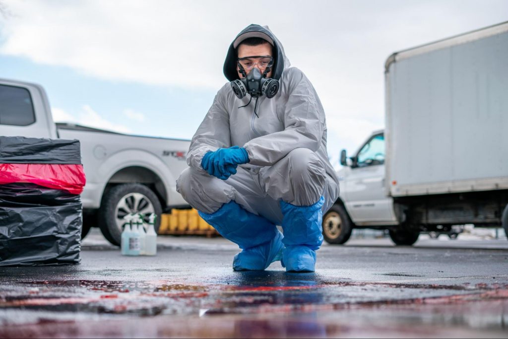 Close-up of hazard signs and sealed disposal bags used during a professional cleanup