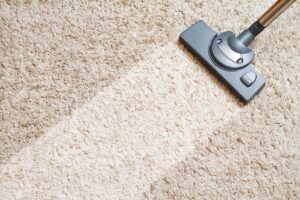 Running a vacuum over a carpet