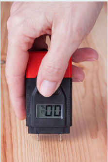 how to fix warped wood floor from water; moisture meter testing during hardwood drying