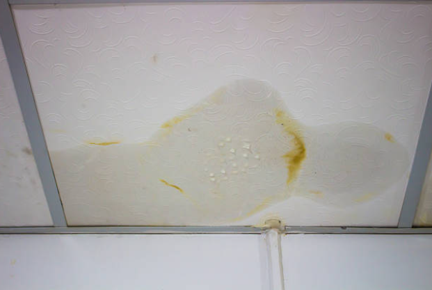 Water damage restoration in Spring Mount warning sign showing ceiling stains from hidden leak
