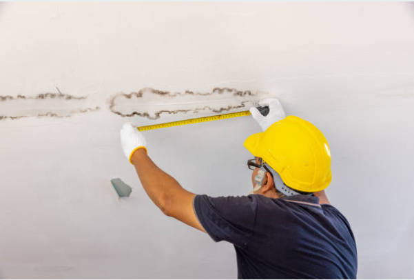 best insurance claim restoration in Blue Bell PA - PuroClean technician assessing flood damage