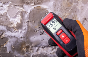 Water damage restoration near me in Montgomery County PA ; professional technician checking moisture levels
