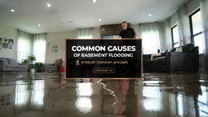 Flooded basement floor reflecting lights and furniture, with