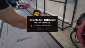 Technician using a moisture meter and drying equipment