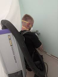 Vacuuming loose soot from wall after house fire in Merced CA