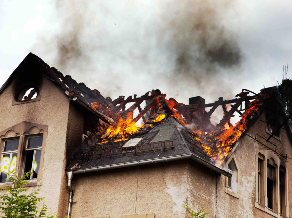 Residential house fire damaging roof structure