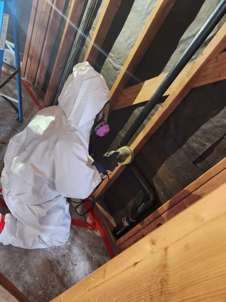 Our technician sanding down the mold growth caused by the patio drain leak.