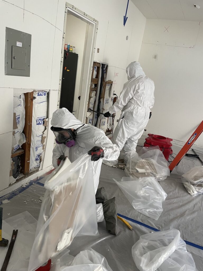 Our team repairing the damage caused by the sink supply line leak.