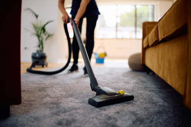 Close up of woman vacuuming while working professional Carpet cleaning services in Nassau County