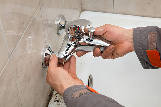 Plumber hands fixing water  tap in a Bathroom Remodeling in Queens