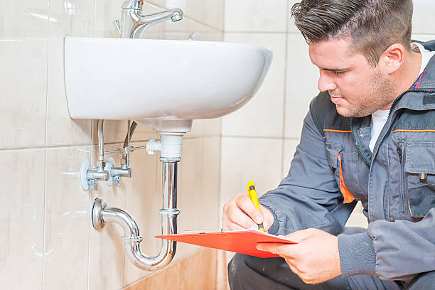 Young Plumber working bathroom remodeling in Nassau County