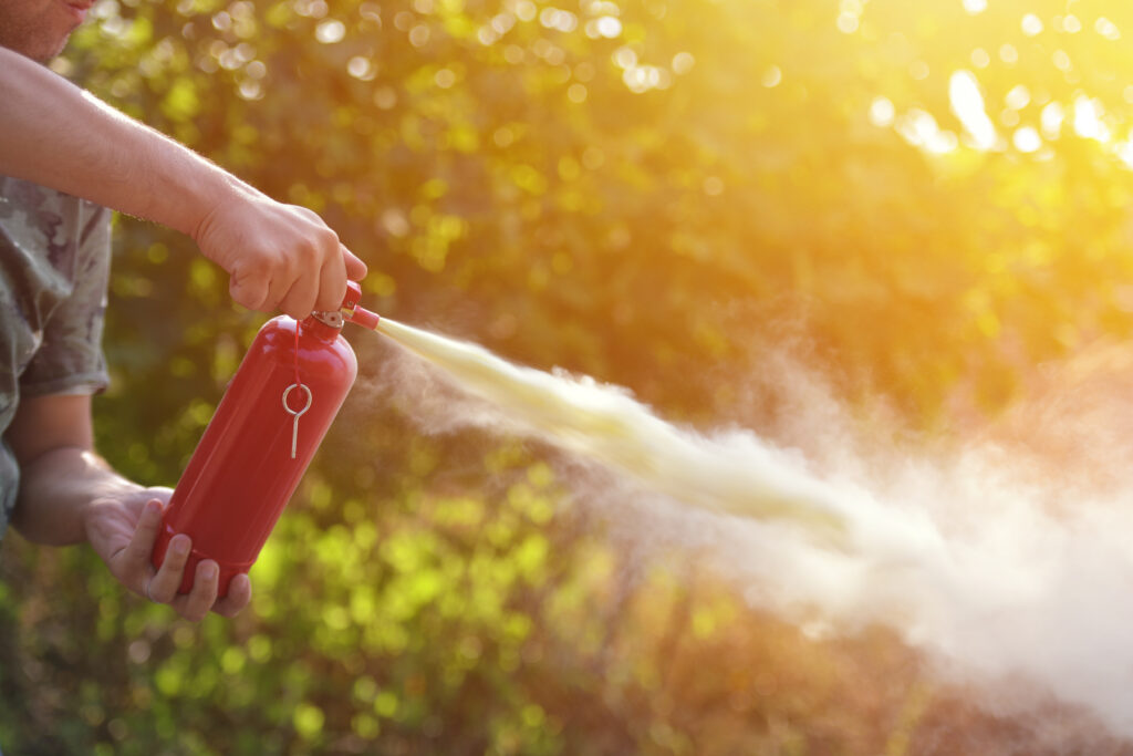 A man demonstrating how to use a fire extinguisher