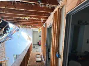 Structural fire damage in a Waterford Township home, showing exposed beams, missing ceiling, and significant internal fire damage.