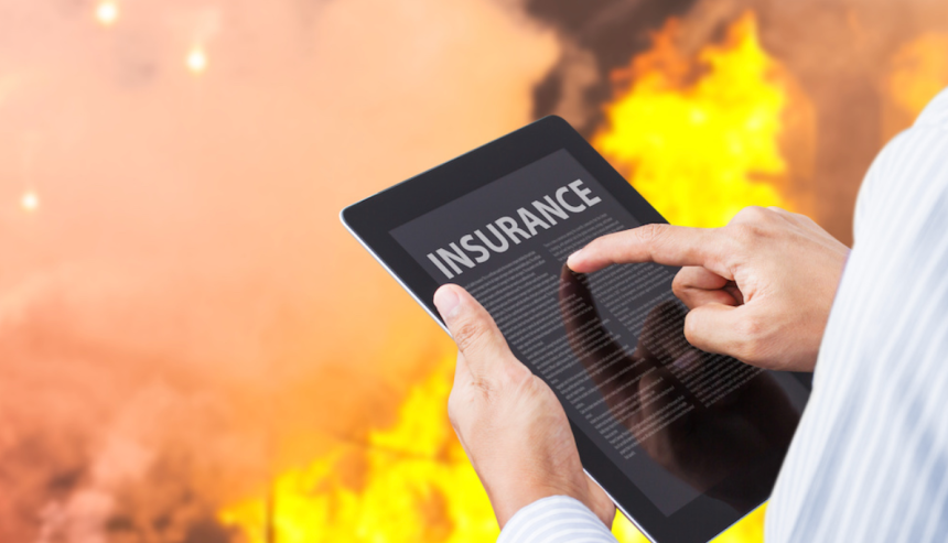 A person reading insurance information on a tablet with a fire background, emphasizing fire damage liability coverage.