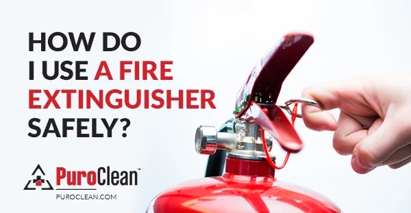 A hand pulls the safety pin from a red fire extinguisher. To the left, bold text asks: “HOW DO I USE A FIRE EXTINGUISHER SAFELY?”, with the PuroClean logo positioned below that text.