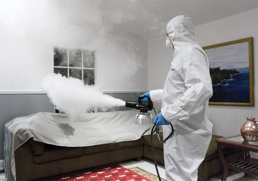 Odor Control professional spraying a couch 