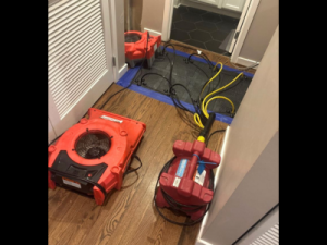 Drying equipment in place as part of a home water damage restoration process, helping remove excess moisture and support proper drying inside a residential space.