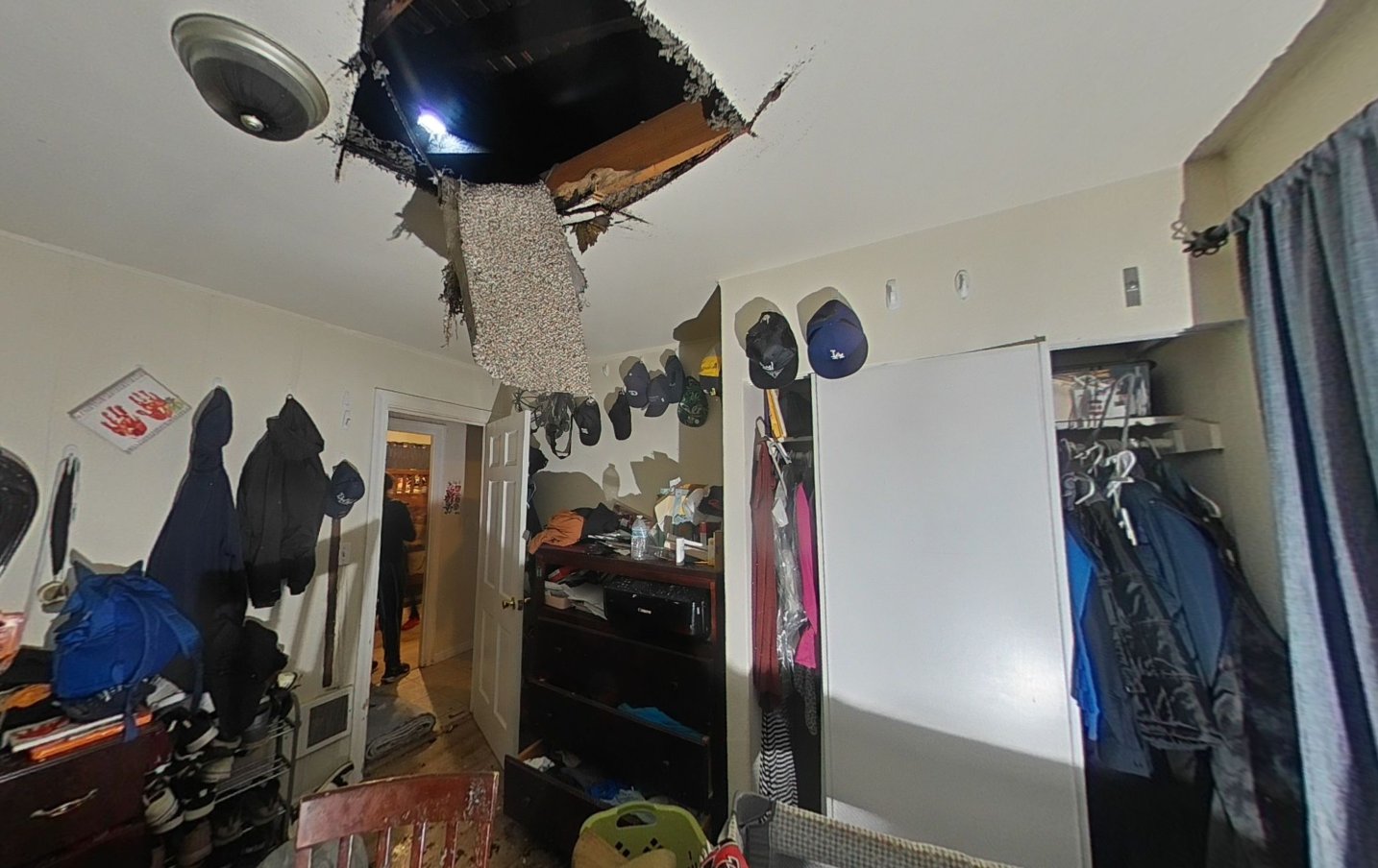 Bedroom with ceiling collapse caused by neighboring unit fire damage